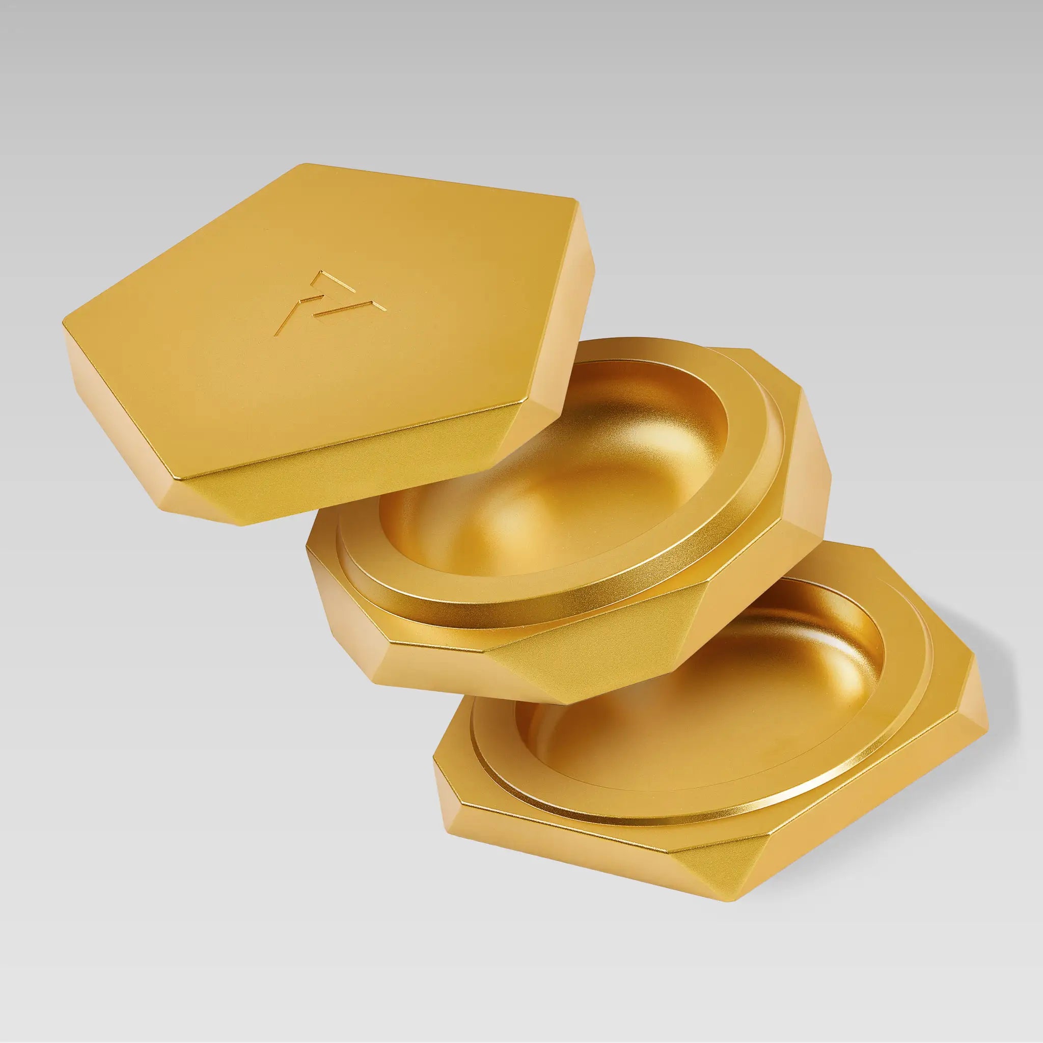 Vesta gold magnetic vessel separated into three parts, showing the stacked compartments