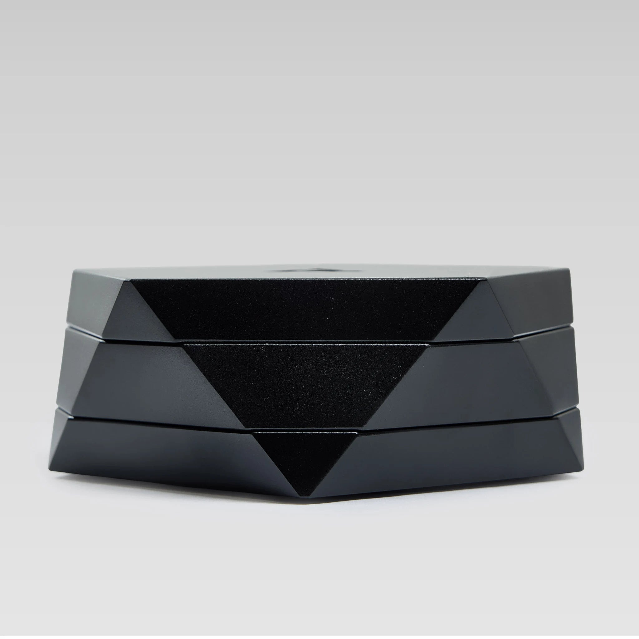 Vesta black magnetic vessel open, low angle showing the faceted geometric body