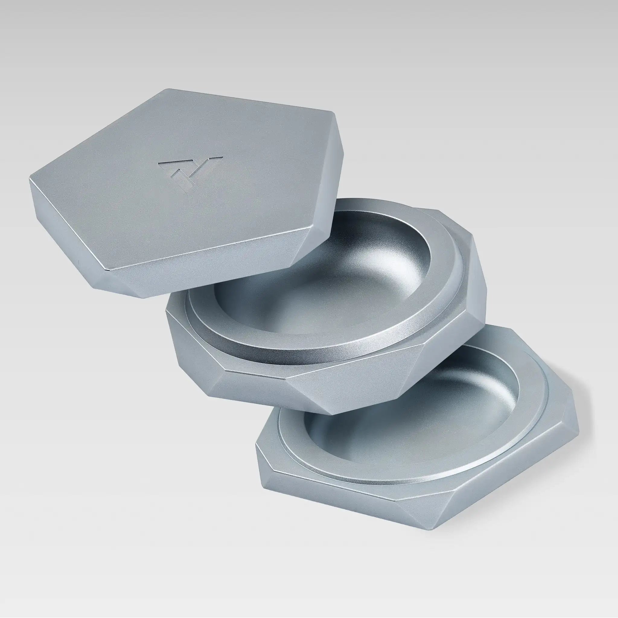 Vesta silver magnetic vessel separated into three parts, showing the stacked compartments