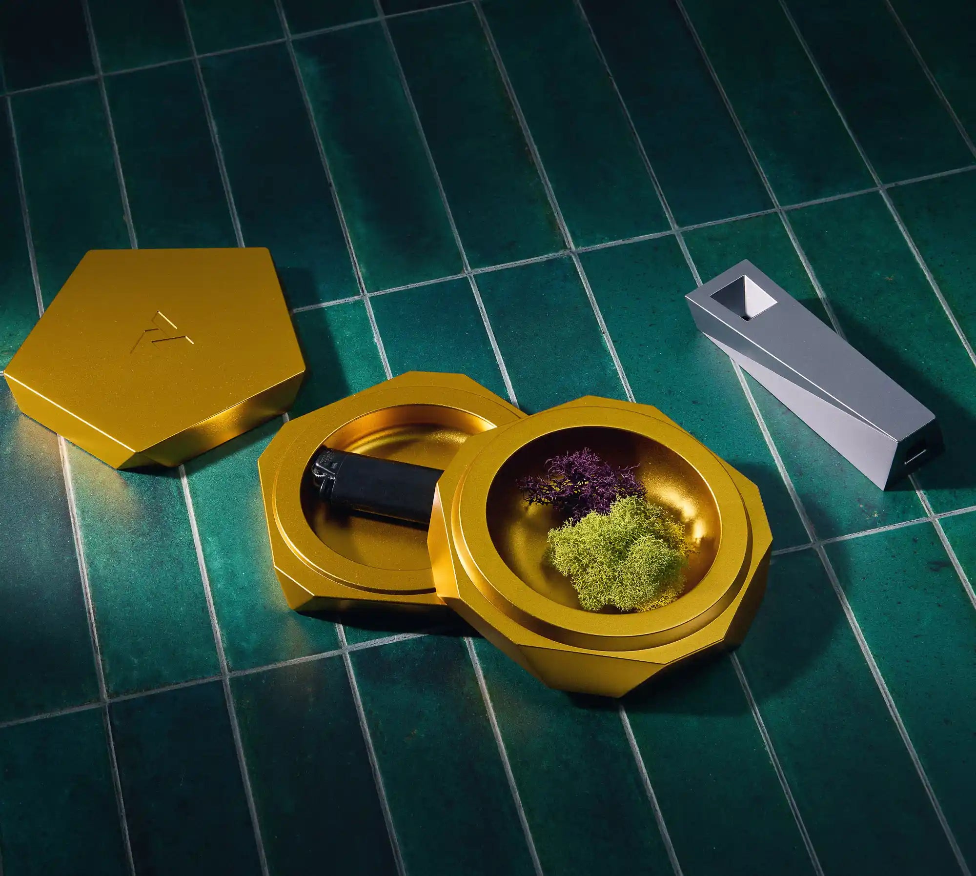 vesta modern storage vessel container opened showing off its two internal chambers, next to a silver Tempest designer relic